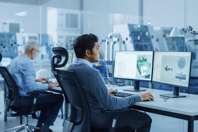 In Clean Workshop Professional Workers in Coveralls and Masks Use Laptop and Talk Inside Factory Office Female Electronics Engineer Works on Computer Screen Shows Printed Circuit Board 3D Design | OMC GROUP