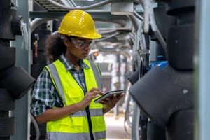 Engineer checking the cooling system of the factory air conditioner | OMC GROUP